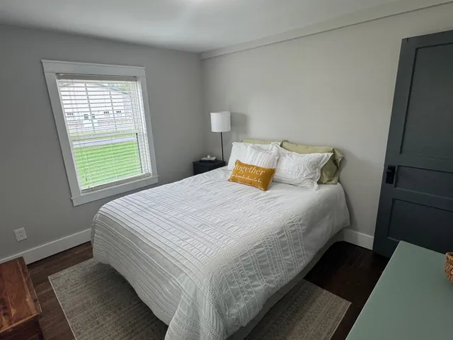 a bedroom with a bed and window