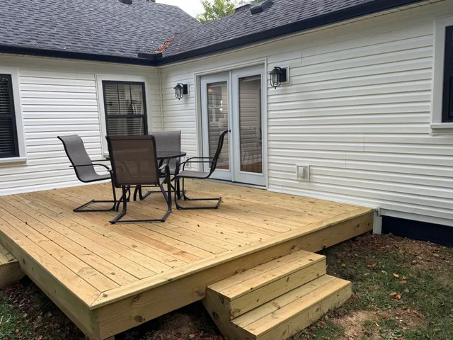 a view of a patio with table and chairs and wooden floor