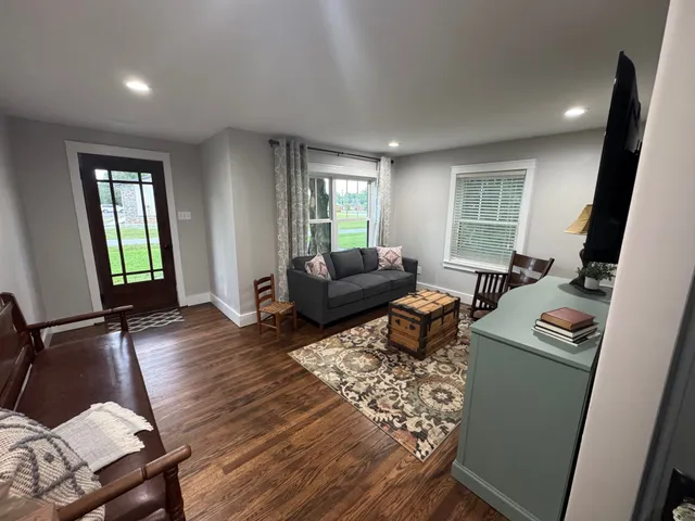 a living room with furniture and a flat screen tv