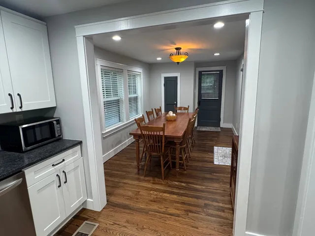 a view of a dining room with furniture and wooden floor