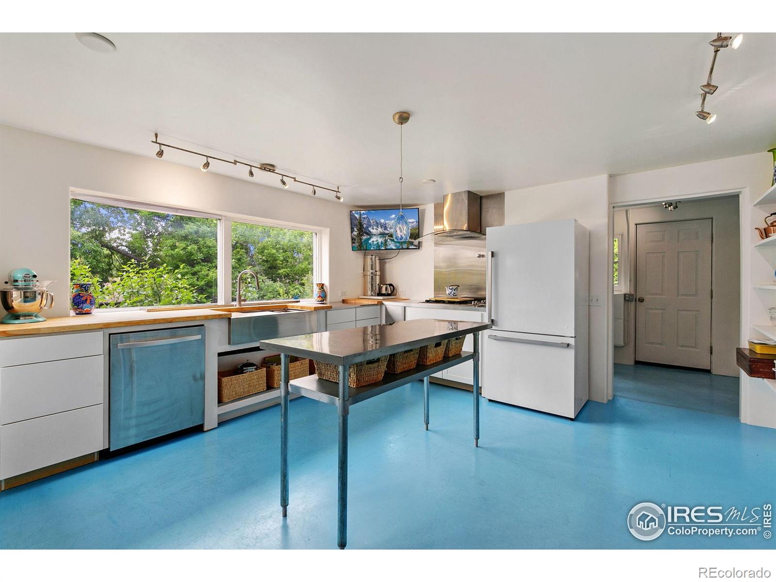 1304 West Prospect Road Fort Collins, CO 80526 - Photo 16 of 29 a kitchen with stainless steel appliances granite countertop a refrigerator a sink dishwasher a stove and a dining table with wooden floor