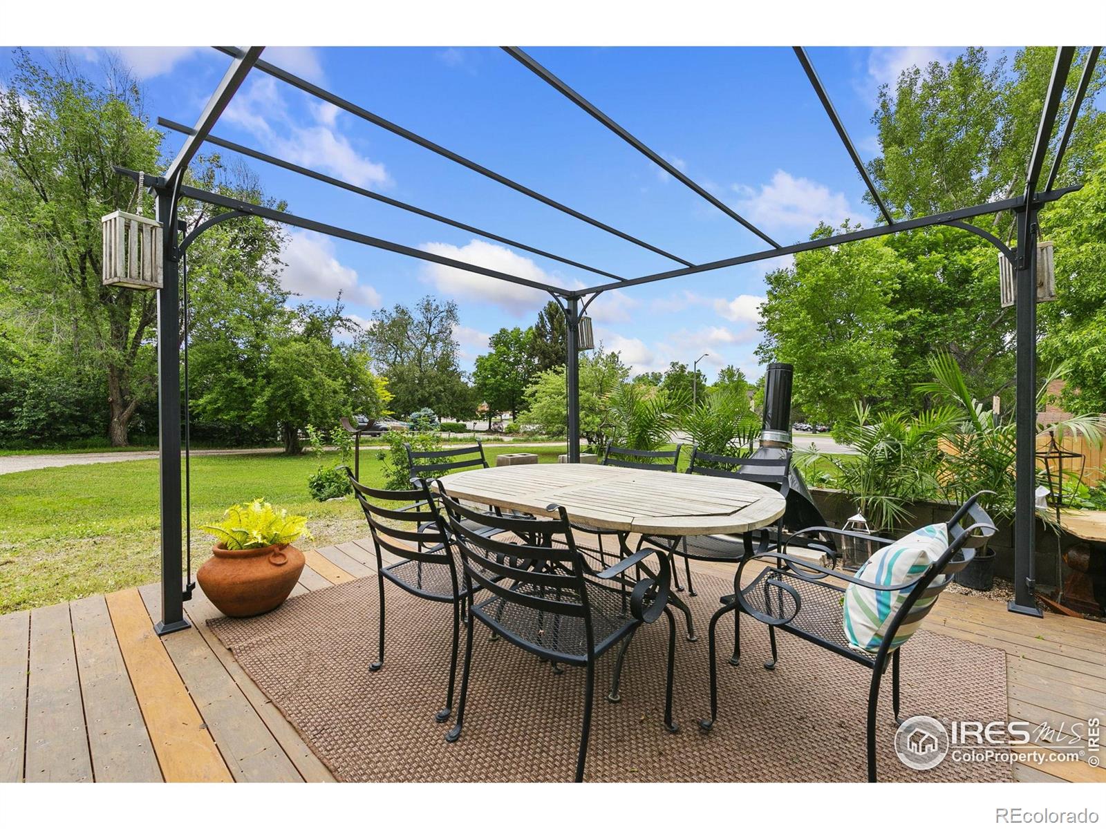 1304 West Prospect Road Fort Collins, CO 80526 - Photo 5 of 29 a view of a patio with table and chairs under an umbrella