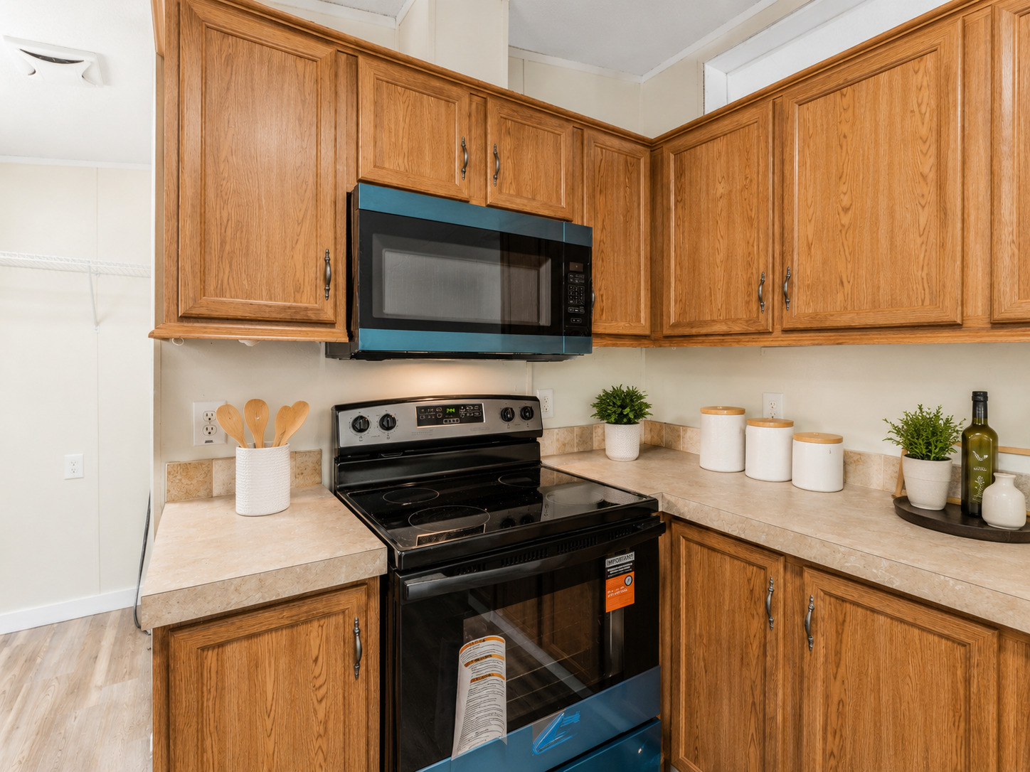 171 Railyard Drive Kyle, TX 78640 - Photo 9 of 20 a kitchen with granite countertop wooden cabinets and a stove top oven