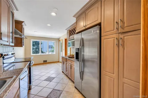 a kitchen with stainless steel appliances granite countertop a sink and a refrigerator