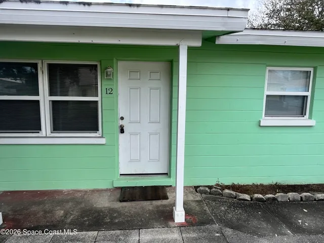 a green house with a yard