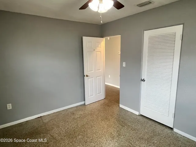 an empty room with a view of hallway