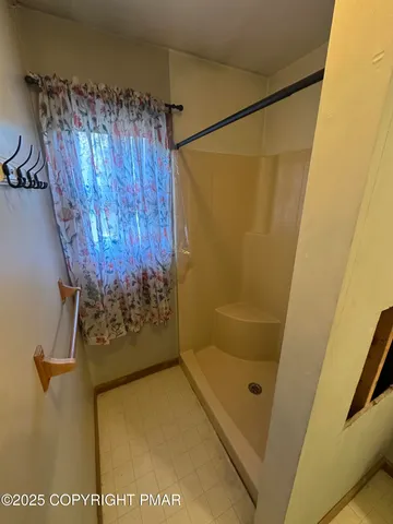 a bathroom with a shower and a tub