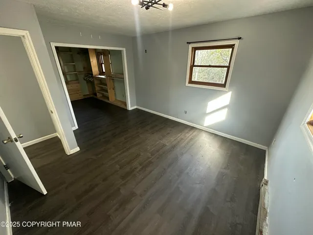 wooden floor with windows and closet
