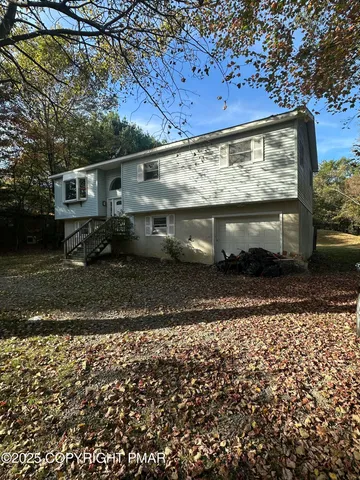 a view of backyard with wooden fence