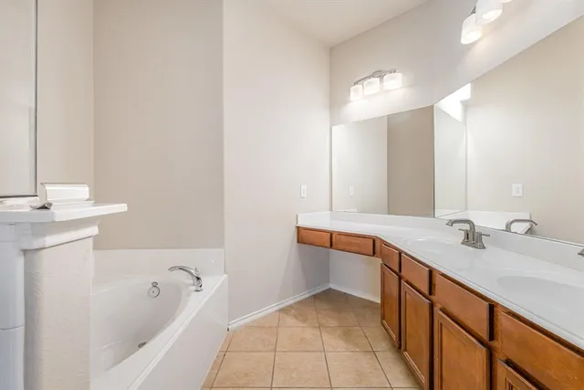 a bathroom with a tub sink and mirror