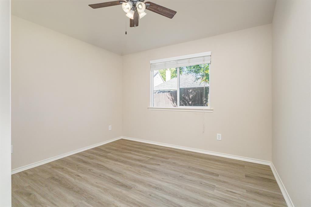 9732 Hedge Bell Drive McKinney, TX 75072 - Photo 19 of 24 an empty room with a window and a ceiling fan