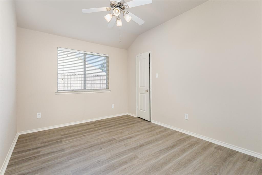 9732 Hedge Bell Drive McKinney, TX 75072 - Photo 20 of 24 an empty room with wooden floor closet and windows
