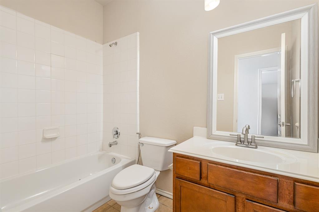 9732 Hedge Bell Drive McKinney, TX 75072 - Photo 21 of 24 a bathroom with a sink a toilet and a bathtub