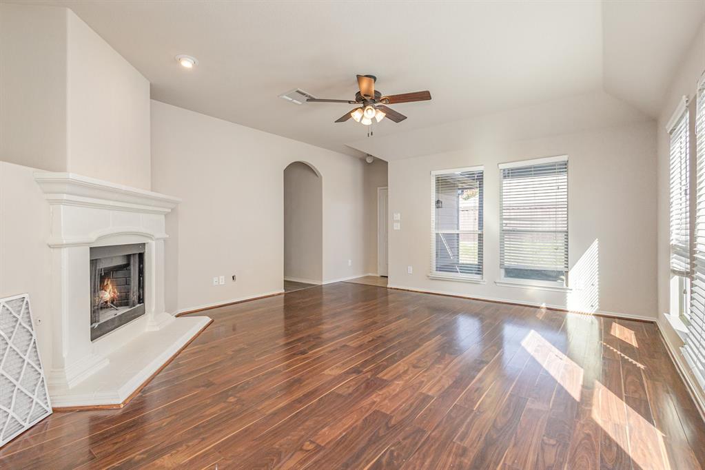 9732 Hedge Bell Drive McKinney, TX 75072 - Photo 6 of 24 a view of an empty room with wooden floor and a window