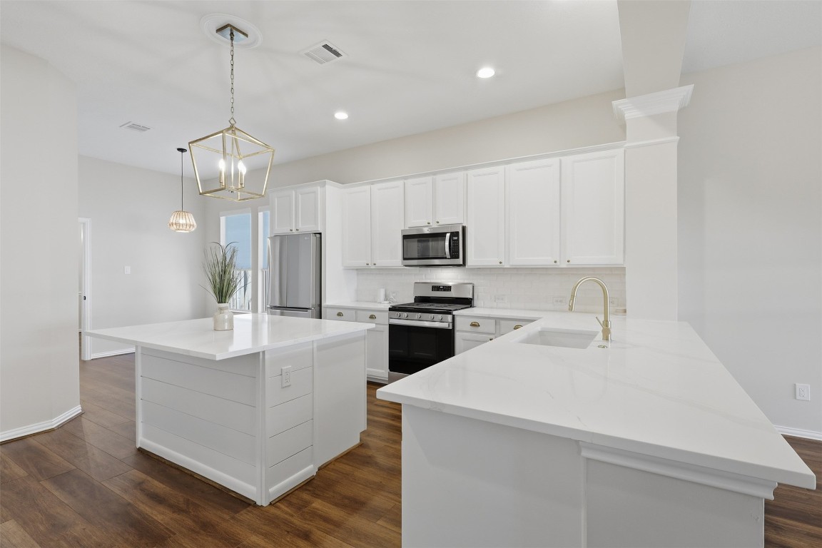 66 Whetstone Ridge Way Spring, TX 77382 - Photo 15 of 39 This gorgeous kitchen was updated in 2025 with quartz countertops, a GFCI outlet installed on the island, and a garbage disposal. Please note the potential for bar seating at the kitchen island.