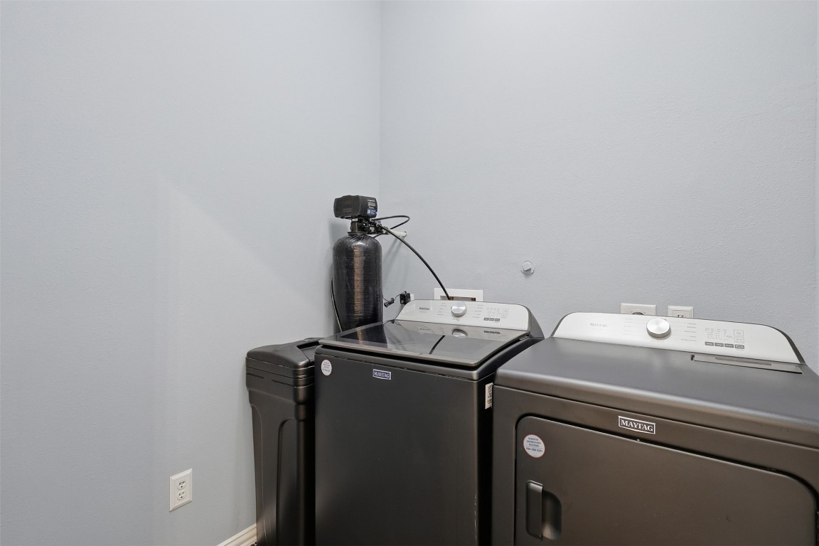 66 Whetstone Ridge Way Spring, TX 77382 - Photo 20 of 39 The private utility room is located inside the home and features a washer, dryer, and an Aquasana water softener. Not pictured is black penny tile flooring.