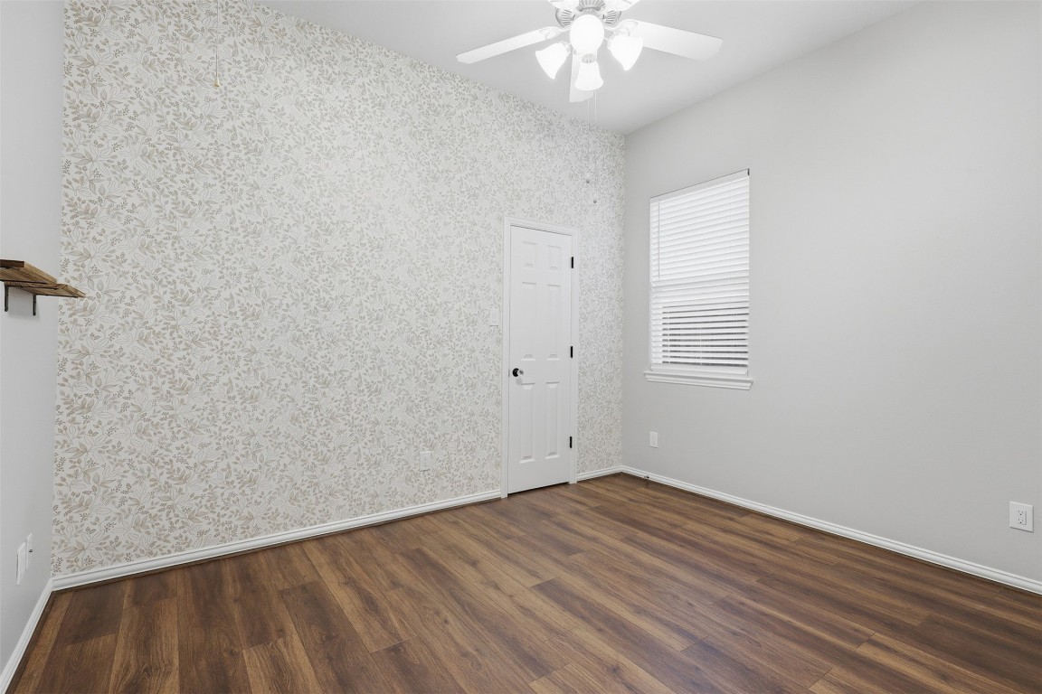 66 Whetstone Ridge Way Spring, TX 77382 - Photo 21 of 39 This secondary bedroom features luxury wide plank vinyl flooring, overhead ceiling fan, window blinds, and a decorative accent wall.