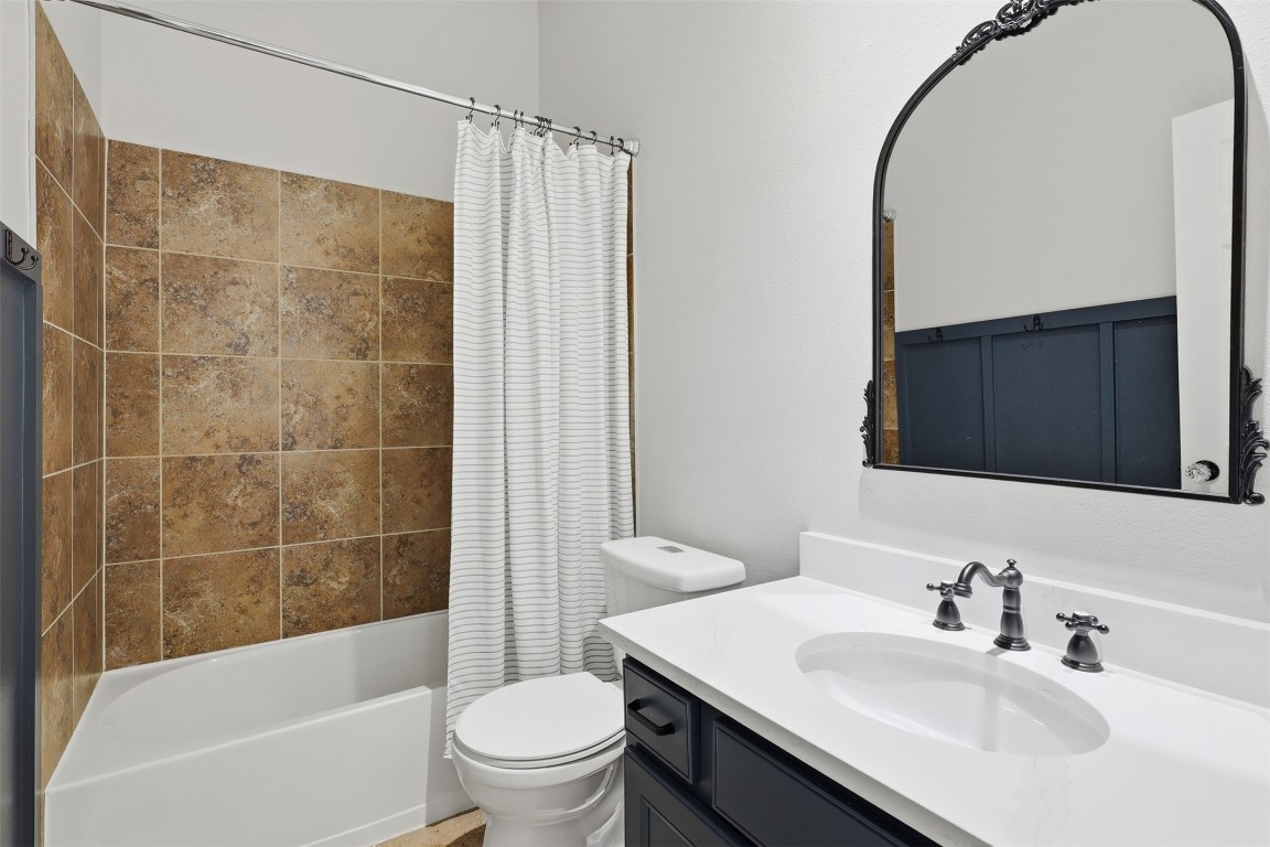66 Whetstone Ridge Way Spring, TX 77382 - Photo 22 of 39 The updated secondary bathroom features a recent Delta toilet, decorative mirror, updated countertops with sink and faucets. The painted accent wall features hooks to hang bathroom towels.