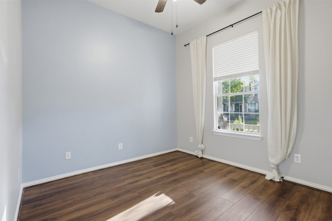 66 Whetstone Ridge Way Spring, TX 77382 - Photo 23 of 39 This secondary bedroom features a view toward the front yard, luxury wide plank vinyl flooring, overhead ceiling fan, blinds, curtains and accent wall.