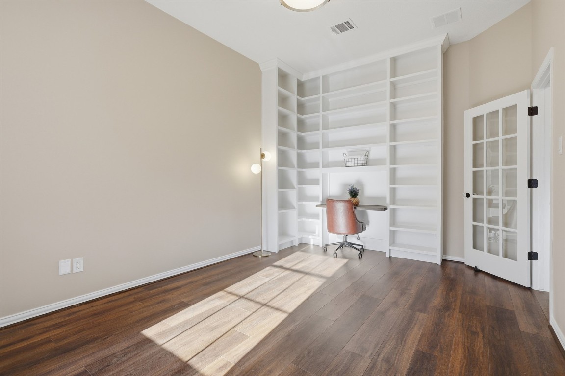 66 Whetstone Ridge Way Spring, TX 77382 - Photo 24 of 39 The office is located at the front of the home with a door to close for privacy. The custom desk and floor-to-ceiling shelves will keep your books and collections organized.