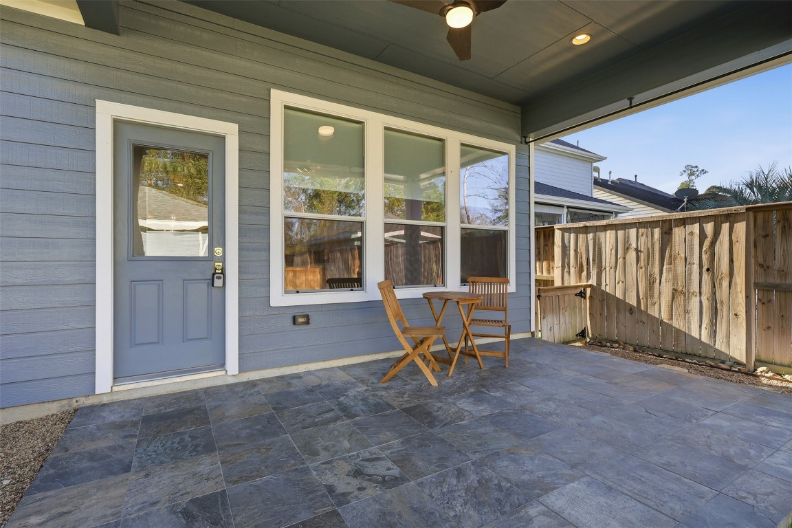 66 Whetstone Ridge Way Spring, TX 77382 - Photo 26 of 39 The covered back patio features overhead recessed lighting, ceiling fan, and recent rustic slate tile flooring.