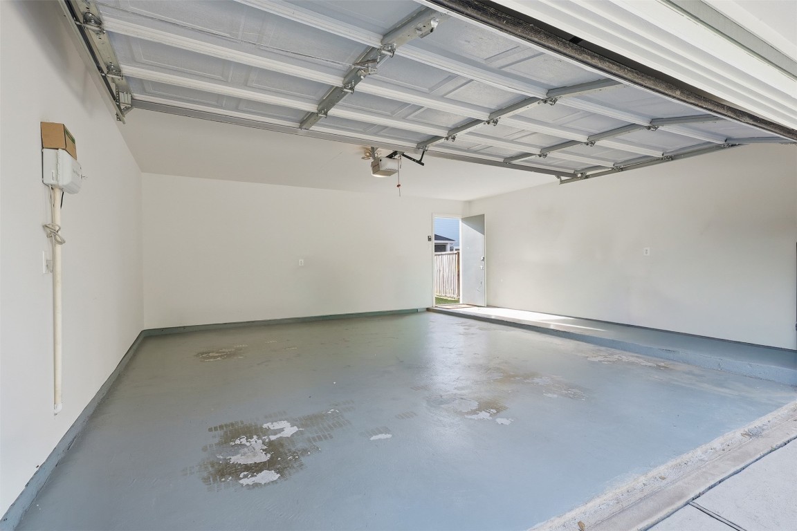 66 Whetstone Ridge Way Spring, TX 77382 - Photo 31 of 39 Two car garage with the interior walls refinished and painted. Please note, this photo was virtually decluttered of household and landscaping items.