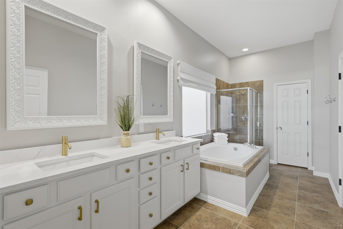 66 Whetstone Ridge Way Spring, TX 77382 - Photo 9 of 39 The primary bathroom recently updated double sinks, countertops, and faucets. The bathroom also includes a soaking tub, standing shower, private water closet, linen closet and walk-in closet.