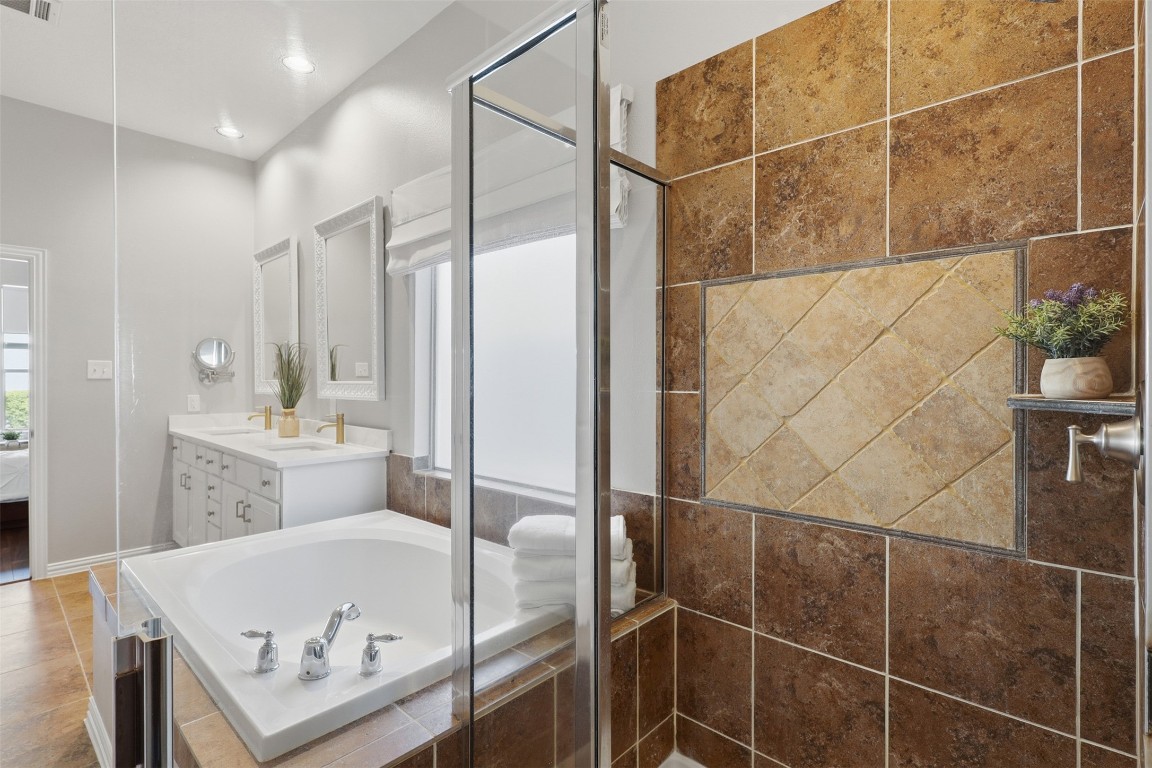 66 Whetstone Ridge Way Spring, TX 77382 - Photo 10 of 39 Notice the accent tile work in the standing shower located next to the separate bathtub.