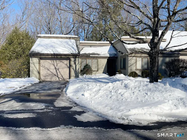 a view of a house with a snow in the yard