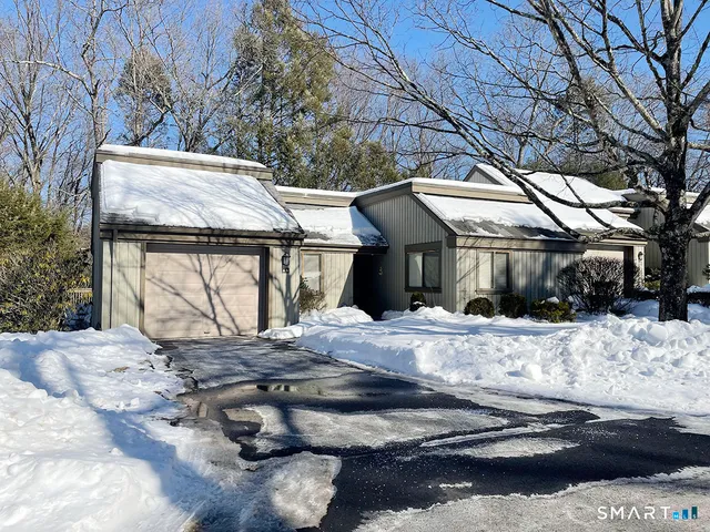 a view of a house with a snow on the road