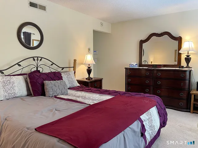 a bedroom with a bed and a dresser