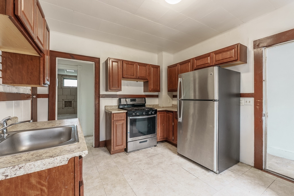 33 Littleton Street Springfield, MA 01104 - Photo 12 of 19 a kitchen with stainless steel appliances granite countertop a refrigerator stove and sink