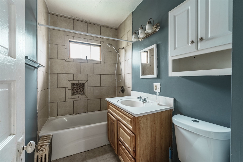 33 Littleton Street Springfield, MA 01104 - Photo 13 of 19 a bathroom with a sink a toilet and bathtub