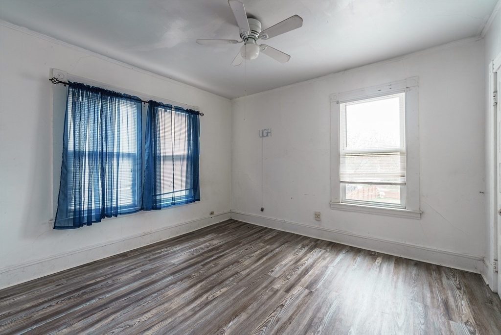 33 Littleton Street Springfield, MA 01104 - Photo 16 of 19 a view of an empty room with wooden floor and a window