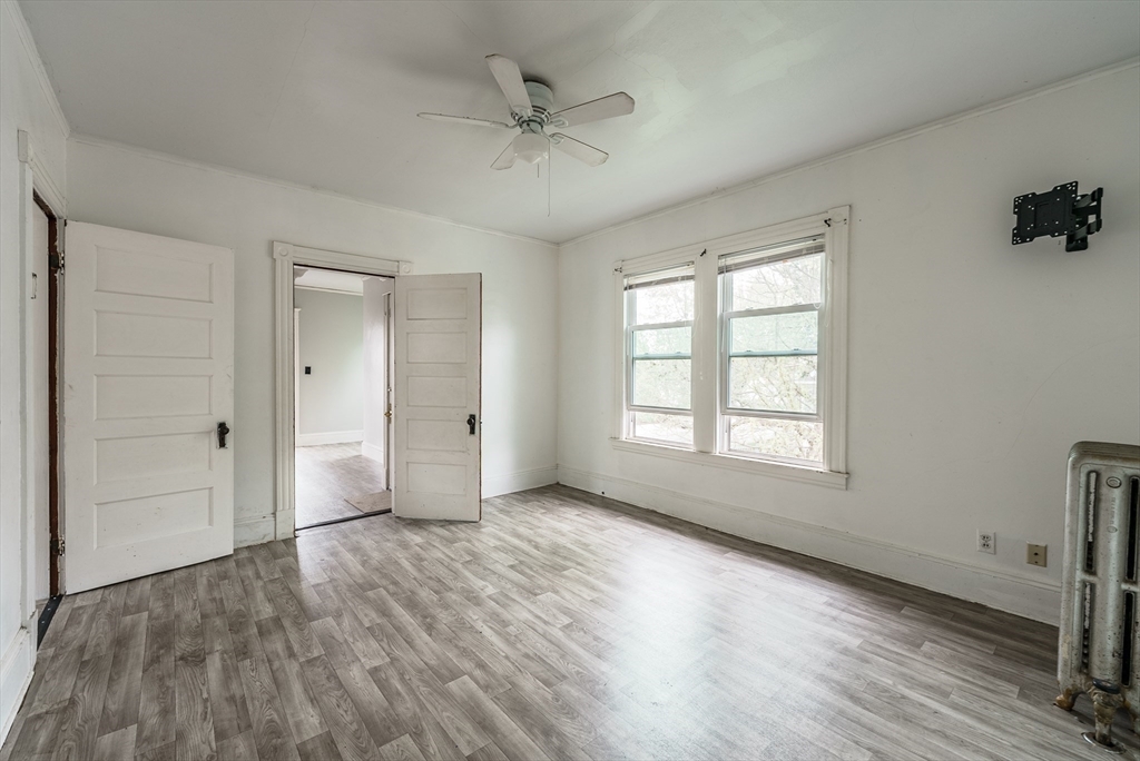 33 Littleton Street Springfield, MA 01104 - Photo 17 of 19 a view of an empty room with a window and wooden floor