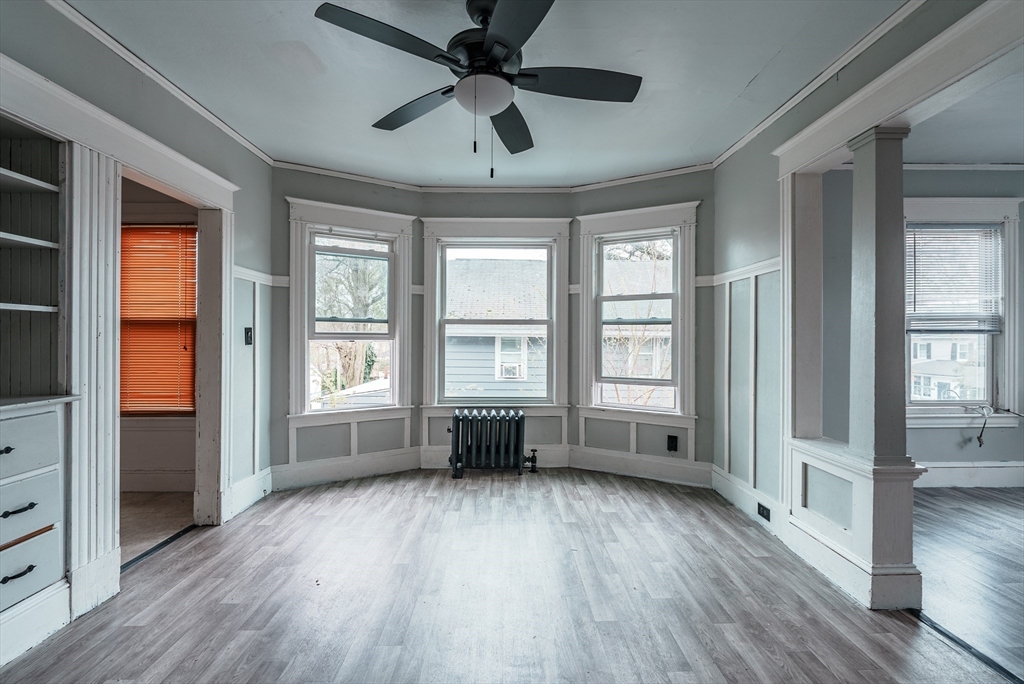 33 Littleton Street Springfield, MA 01104 - Photo 3 of 19 a view of empty room with wooden floor and fan