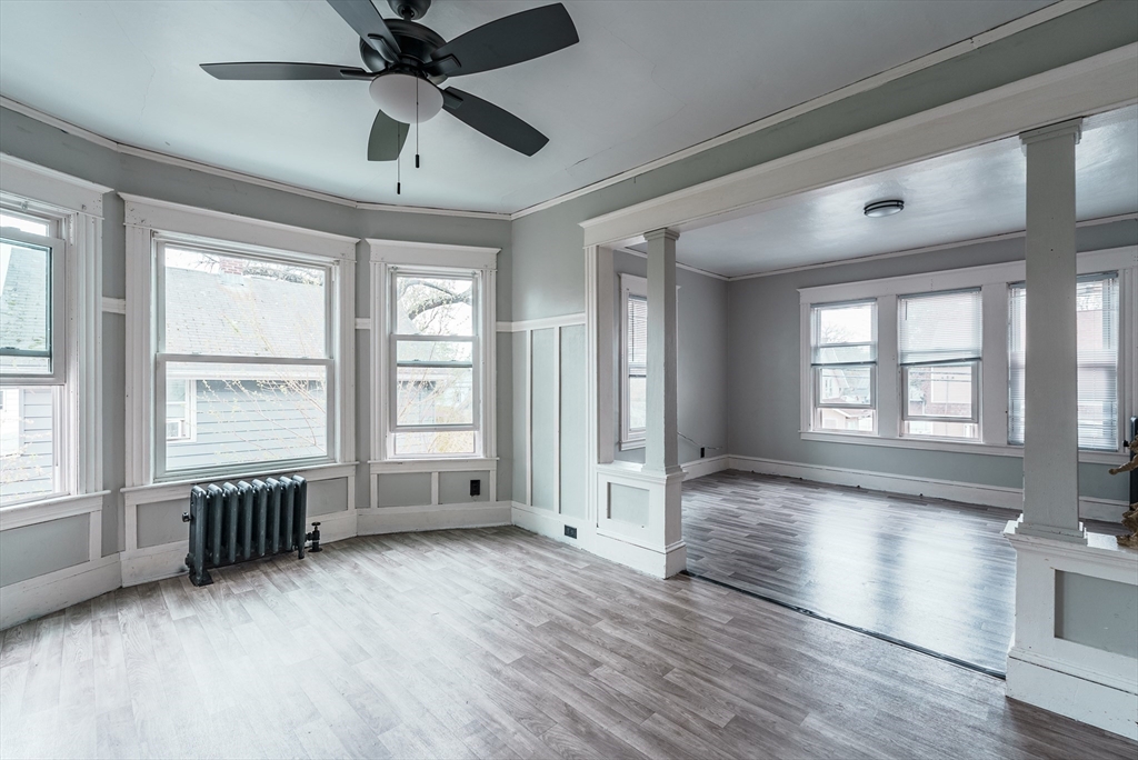 33 Littleton Street Springfield, MA 01104 - Photo 4 of 19 a view of an empty room with a window and wooden floor