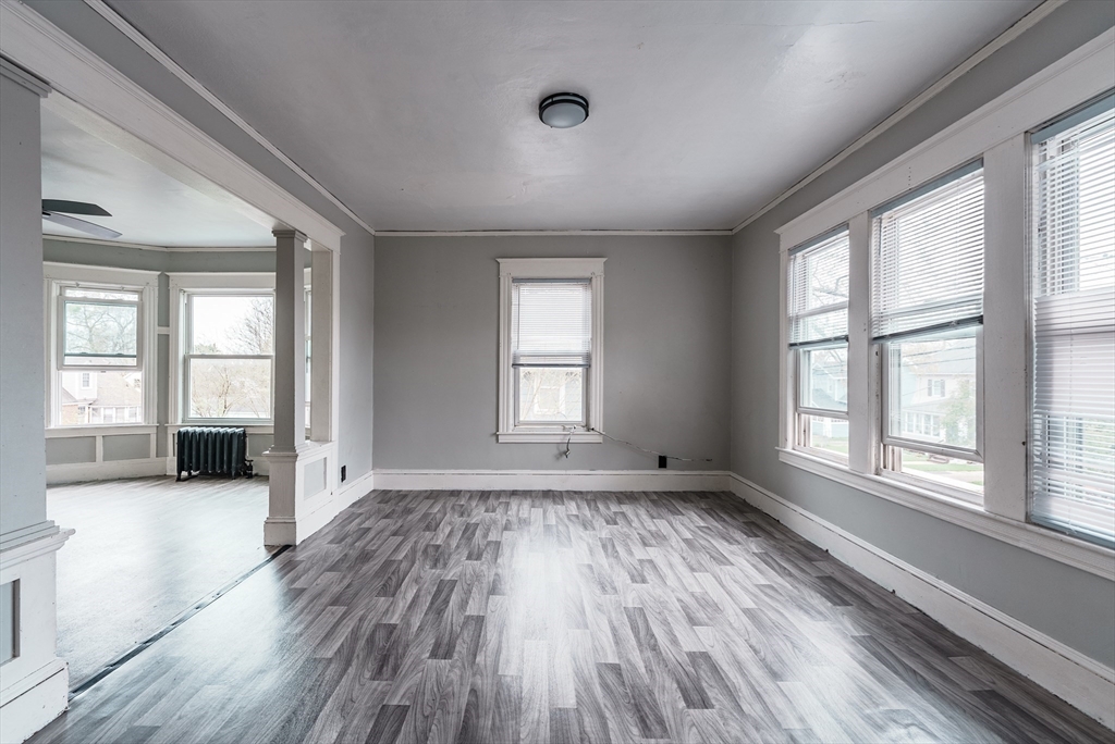 33 Littleton Street Springfield, MA 01104 - Photo 5 of 19 an empty room with wooden floor and windows