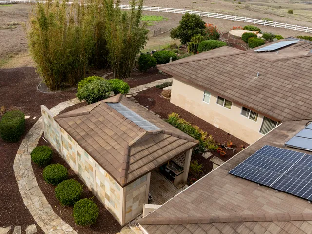 an aerial view of a house with yard swimming pool and outdoor seating