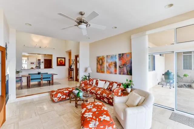 a living room with stainless steel appliances furniture and a fireplace