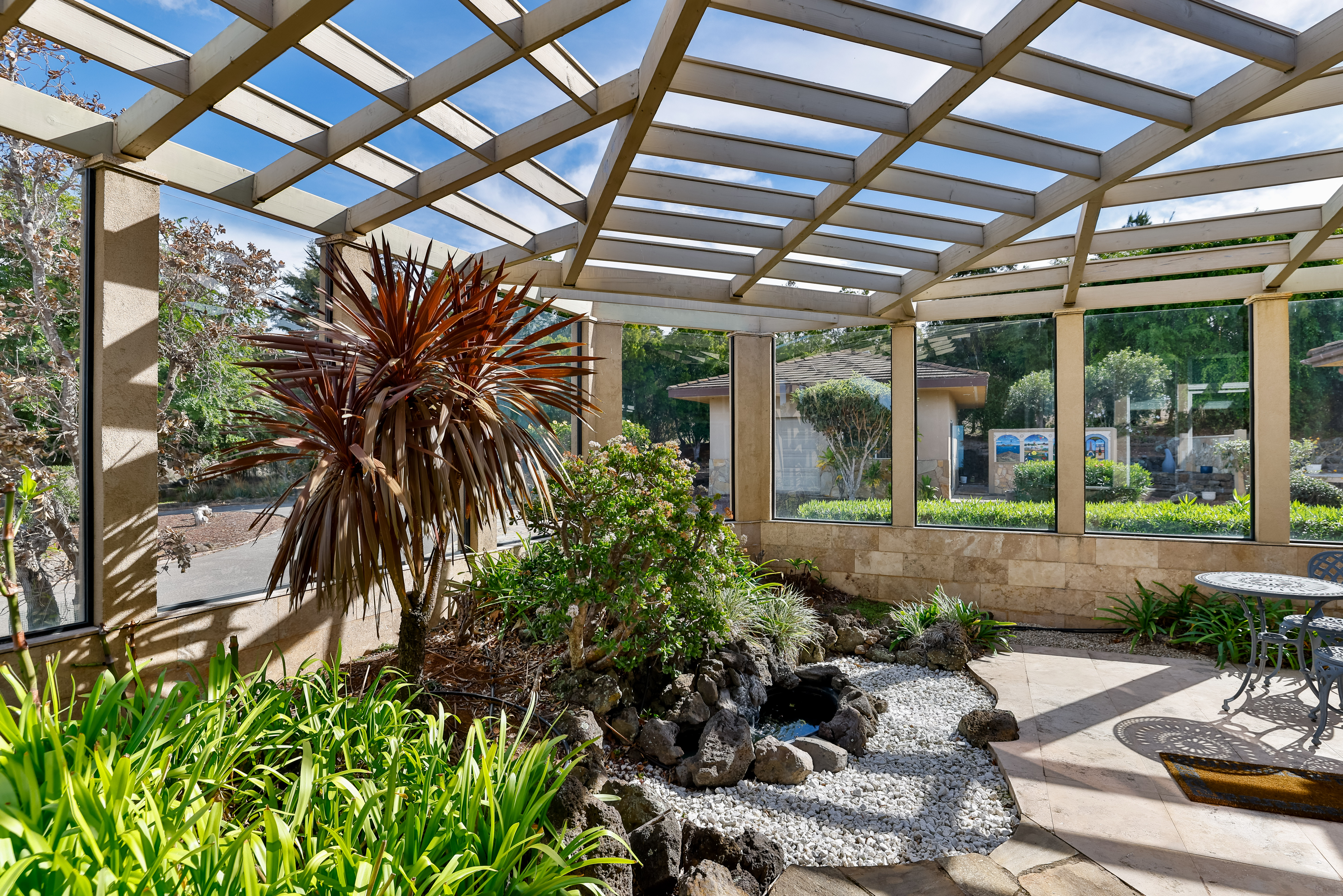 59-1638 Kohala Ranch Road Kamuela, HI 96743 - Photo 5 of 29 a view of a patio with table and chairs potted plants and floor to ceiling window