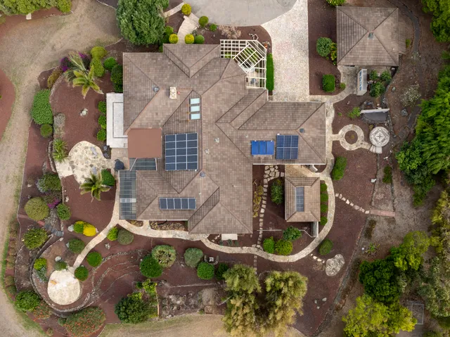 an aerial view of a house with outdoor space