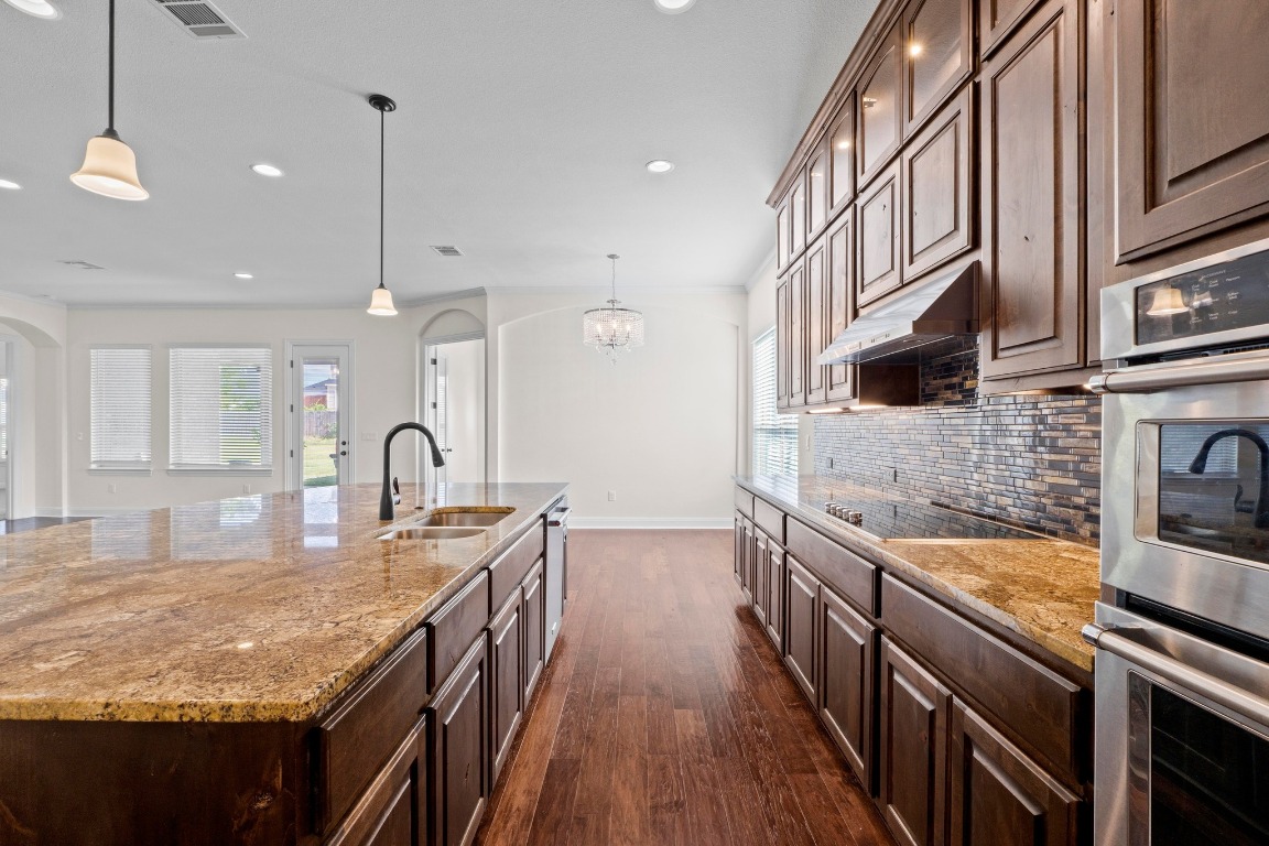 200 Tate Lane Round Rock, TX 78665 - Photo 12 of 40 a kitchen with stainless steel appliances granite countertop a sink and stove