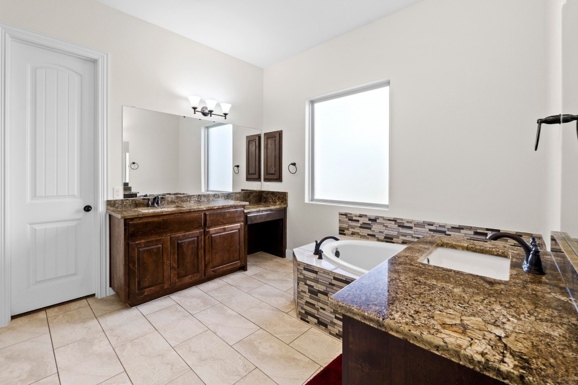 200 Tate Lane Round Rock, TX 78665 - Photo 15 of 40 a kitchen with a sink stove and cabinets