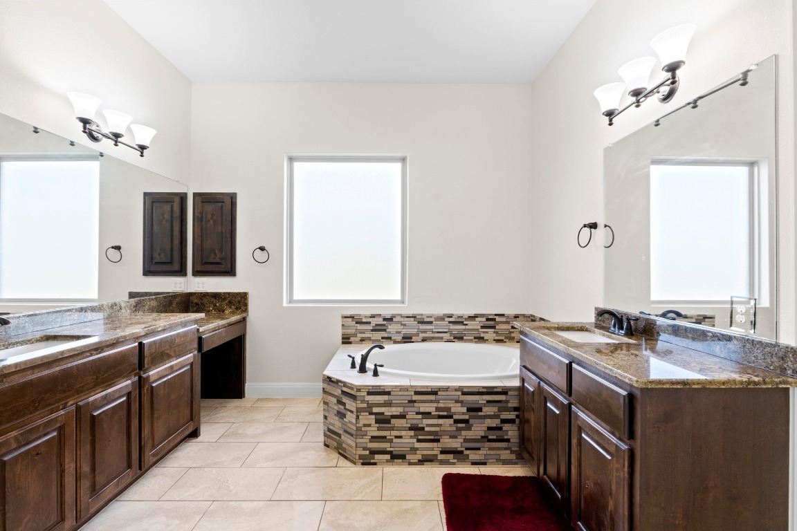 200 Tate Lane Round Rock, TX 78665 - Photo 16 of 40 a bathroom with a sink and a mirror