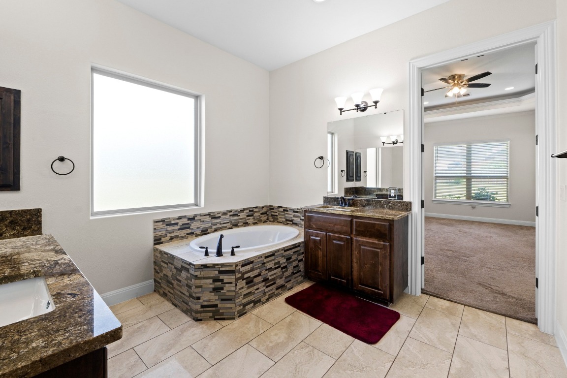200 Tate Lane Round Rock, TX 78665 - Photo 17 of 40 a spacious bathroom with a tub sink and mirror
