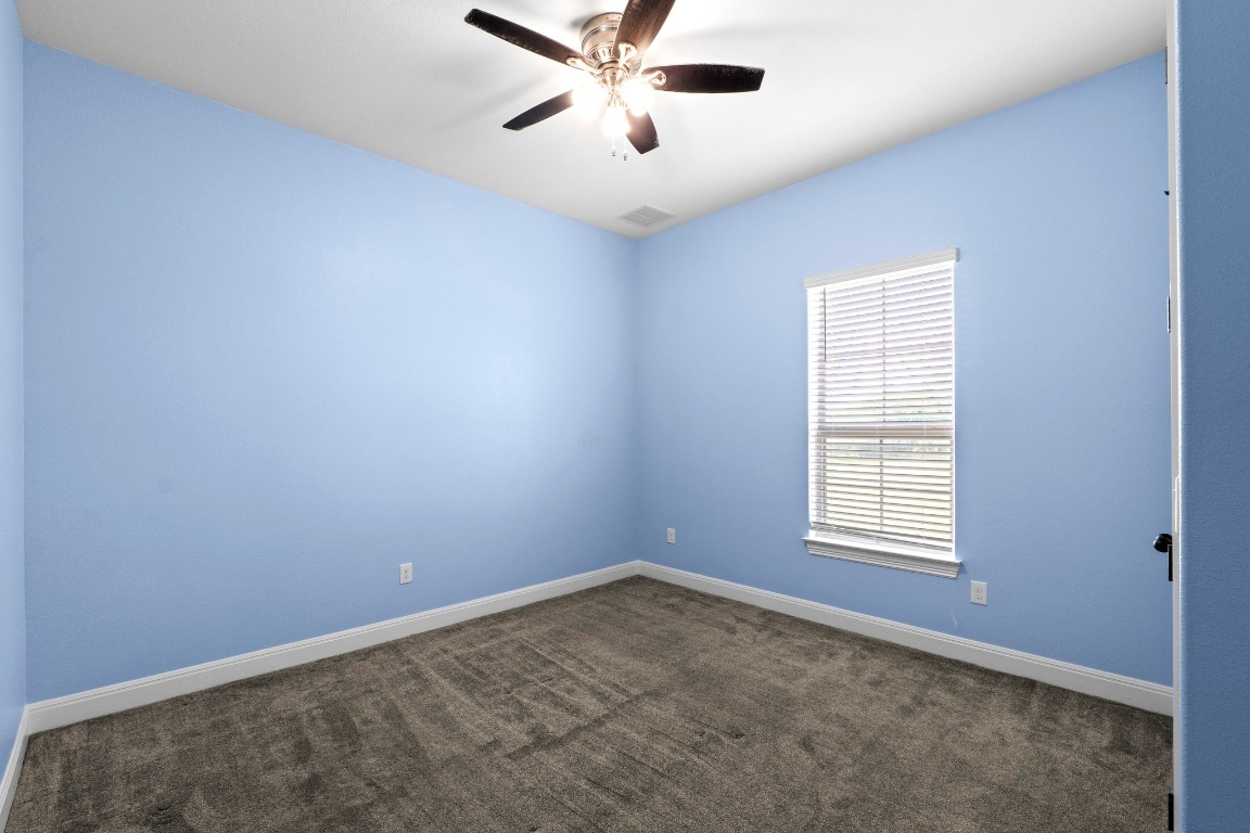 200 Tate Lane Round Rock, TX 78665 - Photo 23 of 40 an empty room with windows and ceiling fan