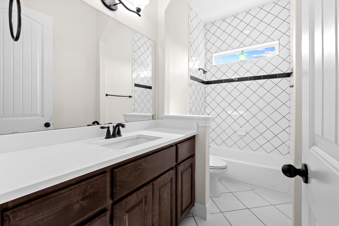 200 Tate Lane Round Rock, TX 78665 - Photo 24 of 40 a bathroom with a sink a toilet and mirror