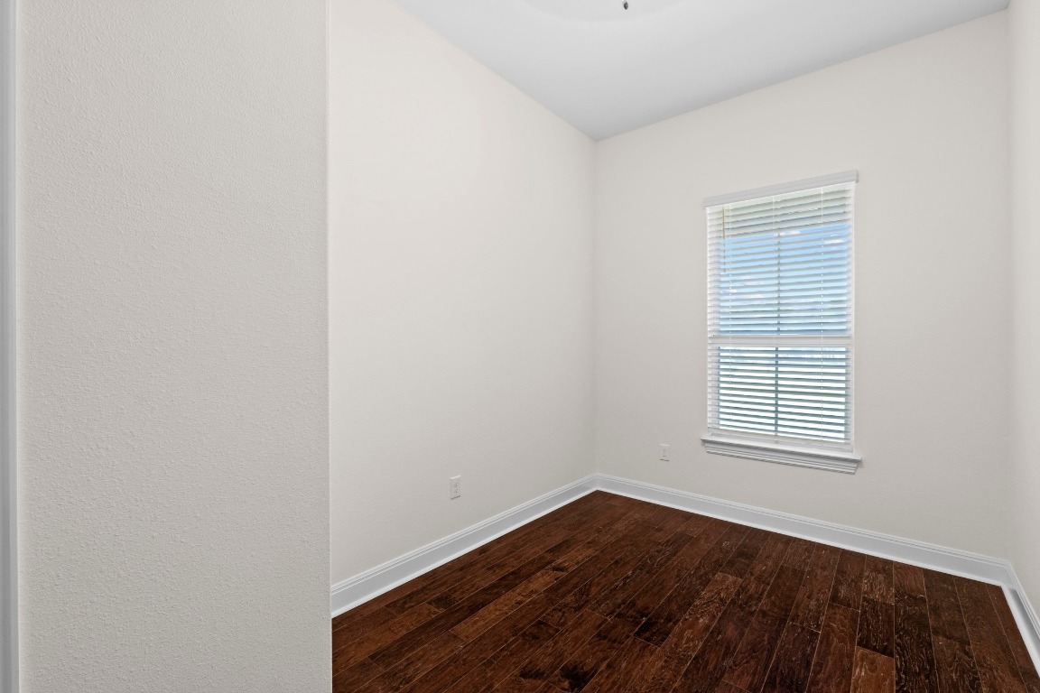 200 Tate Lane Round Rock, TX 78665 - Photo 26 of 40 a view of an empty room with wooden floor and a window