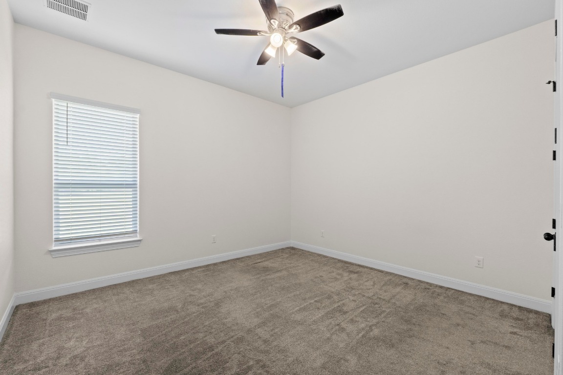200 Tate Lane Round Rock, TX 78665 - Photo 27 of 40 an empty room with a window and a fan